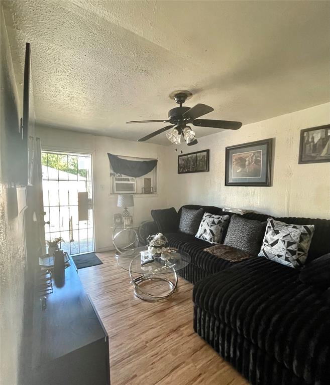 3525 Colonial Avenue Dallas, TX 75215 - Photo 21 of 24 Living area with light wood-style flooring, a textured ceiling, and a ceiling fan