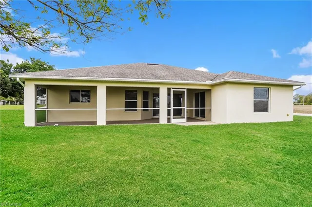 a view of an house with backyard space and balcony