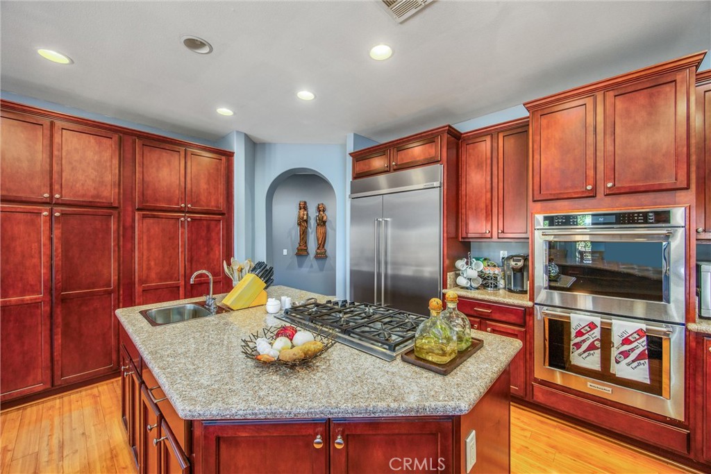 47298 Twin Pines Road Banning, CA 92220 - Photo 14 of 65 a kitchen with stainless steel appliances granite countertop a stove a sink and a cabinets