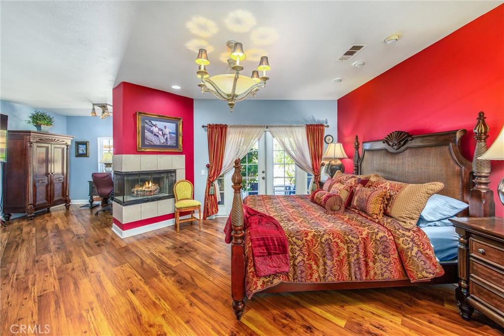 47298 Twin Pines Road Banning, CA 92220 - Photo 21 of 65 a bedroom with a bed and a flat screen tv