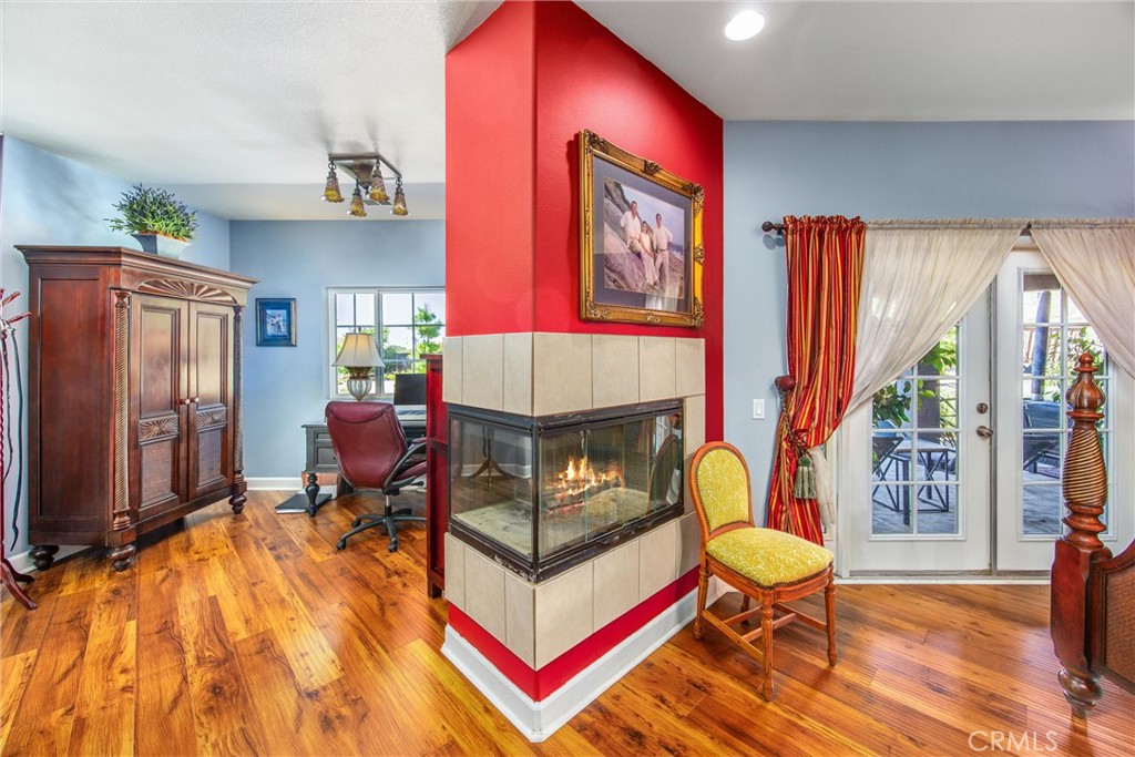 47298 Twin Pines Road Banning, CA 92220 - Photo 22 of 65 a living room with furniture a window and a flat screen tv