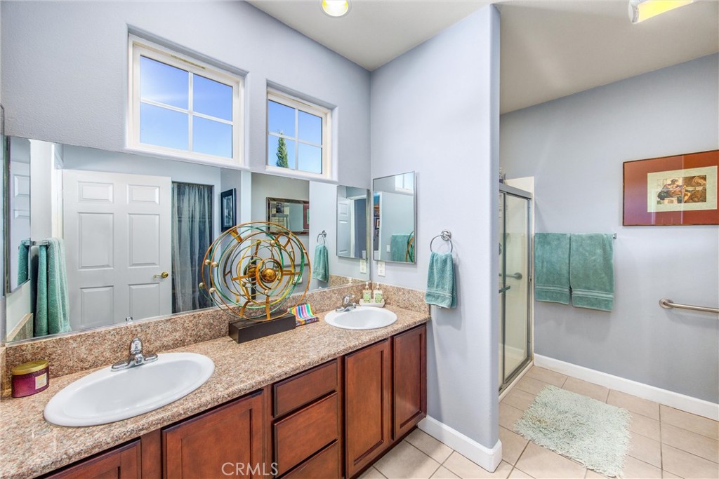 47298 Twin Pines Road Banning, CA 92220 - Photo 39 of 65 a bathroom with a granite countertop sink and a mirror