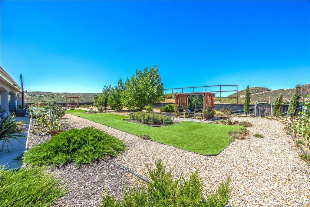 47298 Twin Pines Road Banning, CA 92220 - Photo 57 of 65 a view of a garden with a building in the background