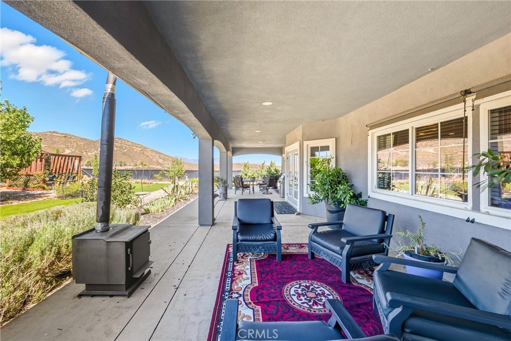 47298 Twin Pines Road Banning, CA 92220 - Photo 63 of 65 a living room with furniture floor to ceiling window next to a yard
