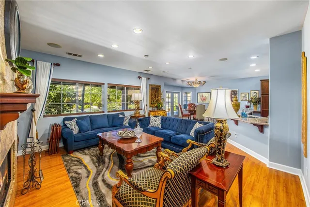a view of a dining room with furniture a chandelier and wooden floor