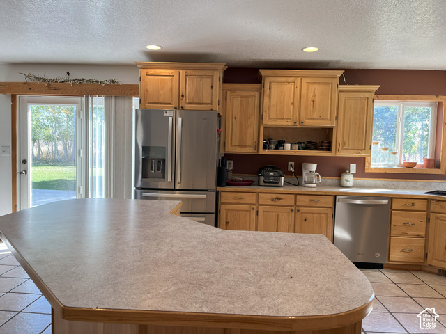 750 South Big Road Soda Springs, ID 83276 - Photo 22 of 40 Kitchen featuring a large island, wood cabinetry, stainless steel appliances, and a window