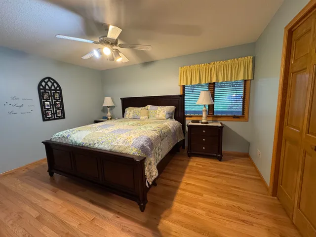 a spacious bedroom with a bed and a chandelier