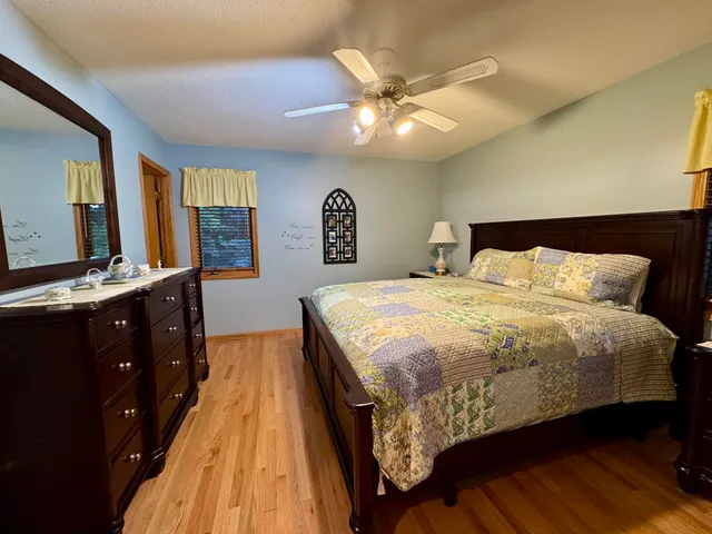 a bedroom with a large bed and a chandelier