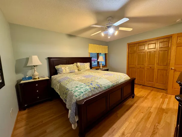 a bedroom with a bed and wooden floor