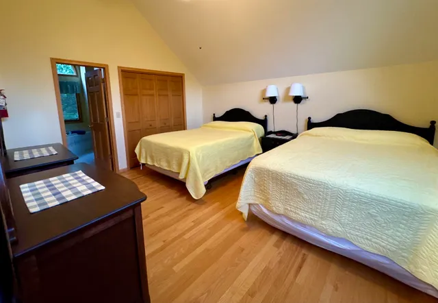 a bedroom with two beds and a window