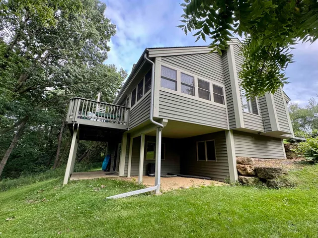 a view of a house with a yard and sitting area
