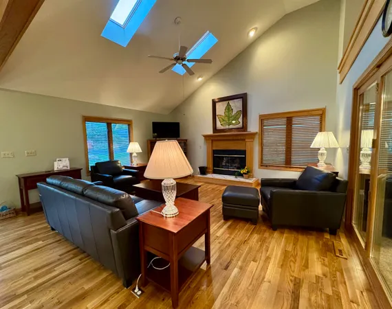 a living room with furniture fireplace and flat screen tv