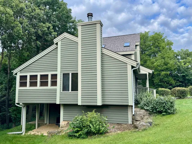 a view of a house with a yard and plants