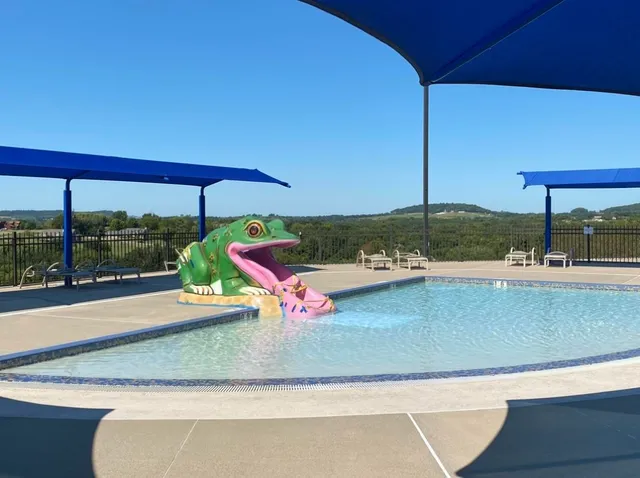 a view of a living room with a floor to ceiling window and wooden floor