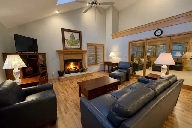 a living room with furniture fireplace and flat screen tv