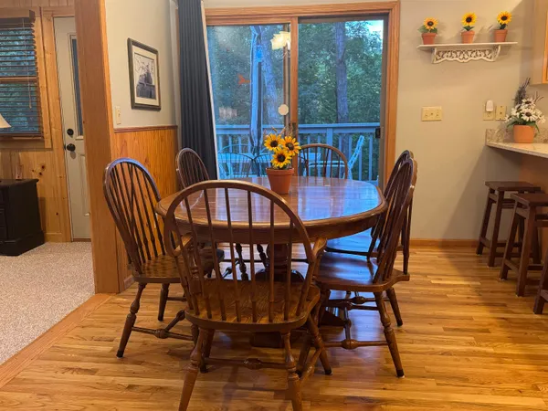 a view of a dining room with furniture and chandelier