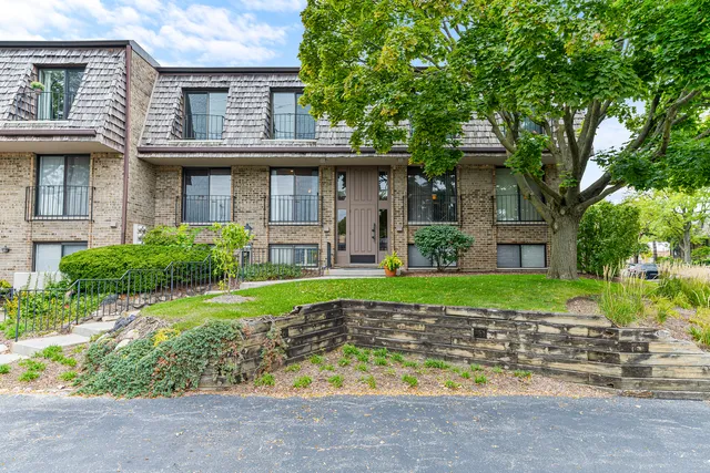 a view of a house with a yard and plants