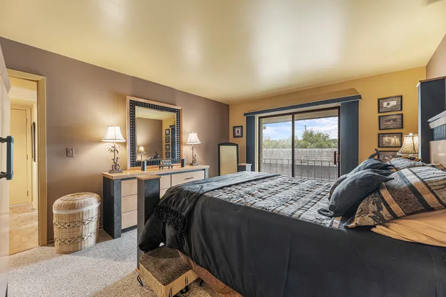 a bedroom with a bed and a mirror