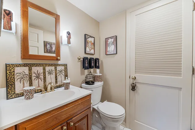 a bathroom with a sink a toilet and mirror