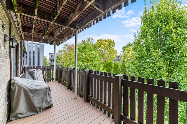a view of a roof deck with couches and wooden floor