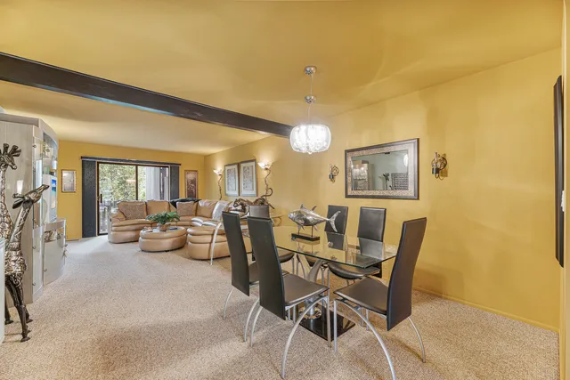 a view of a dining room with furniture and chandelier