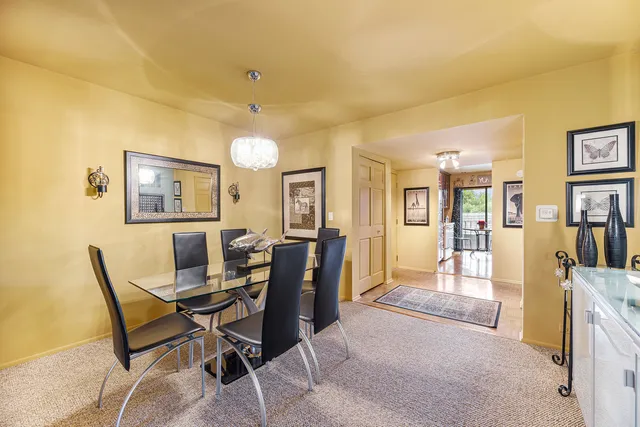 a view of a dining room with furniture and a bookshelf