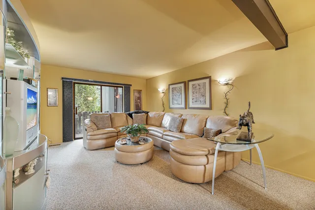 a living room with furniture and a potted plant