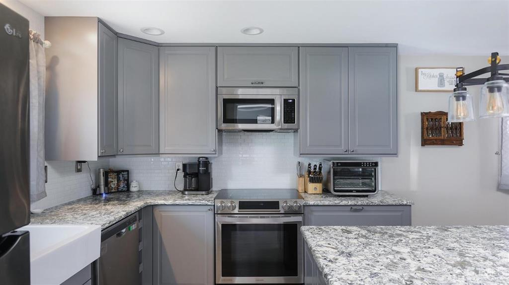 174 South Hill Road Colonia, NJ 07067 - Photo 13 of 31 a kitchen with stainless steel appliances granite countertop a stove a sink and a microwave