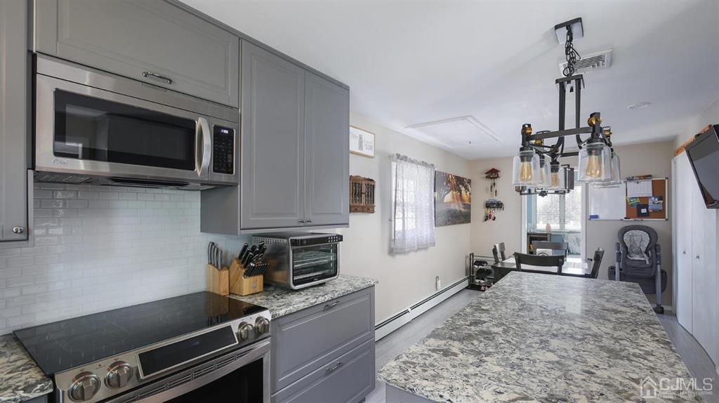 174 South Hill Road Colonia, NJ 07067 - Photo 14 of 31 a kitchen with a stove and a microwave