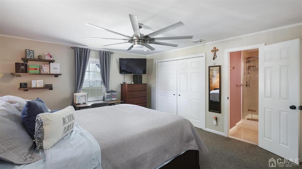 174 South Hill Road Colonia, NJ 07067 - Photo 16 of 31 a bedroom with a bed and a chandelier