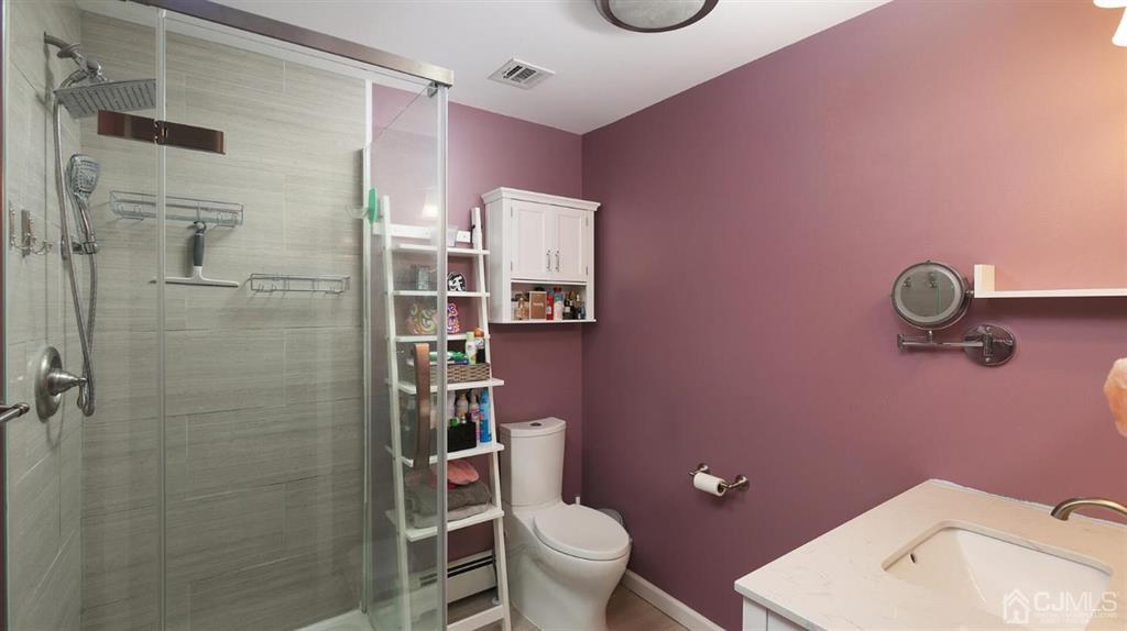 174 South Hill Road Colonia, NJ 07067 - Photo 17 of 31 a bathroom with a sink a toilet and shower