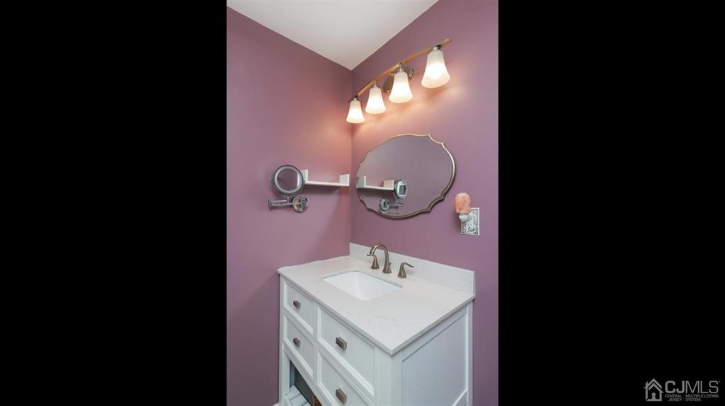 174 South Hill Road Colonia, NJ 07067 - Photo 18 of 31 a bathroom with a sink and a mirror
