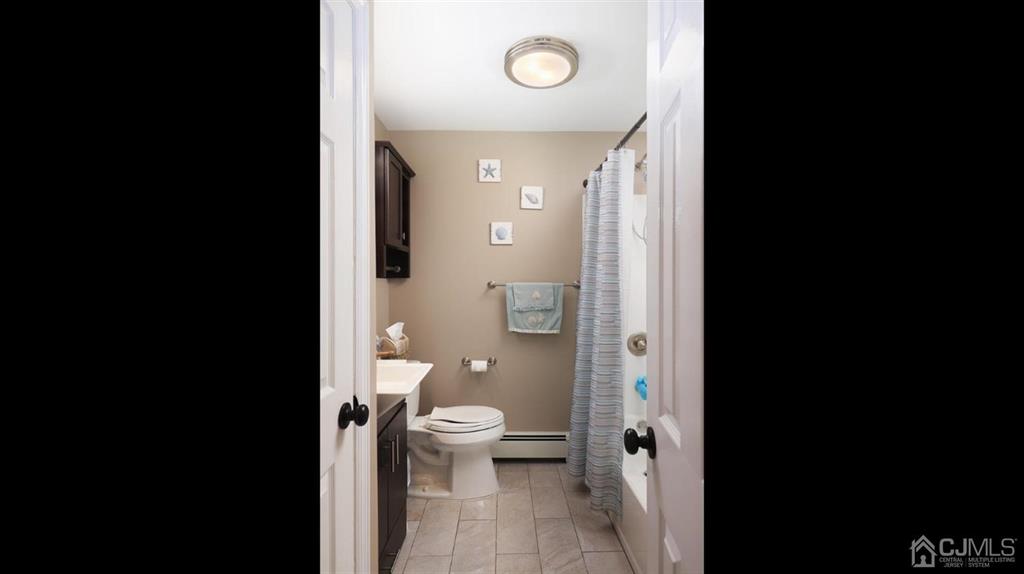 174 South Hill Road Colonia, NJ 07067 - Photo 21 of 31 a view of a bathroom with a toilet sink and a mirror