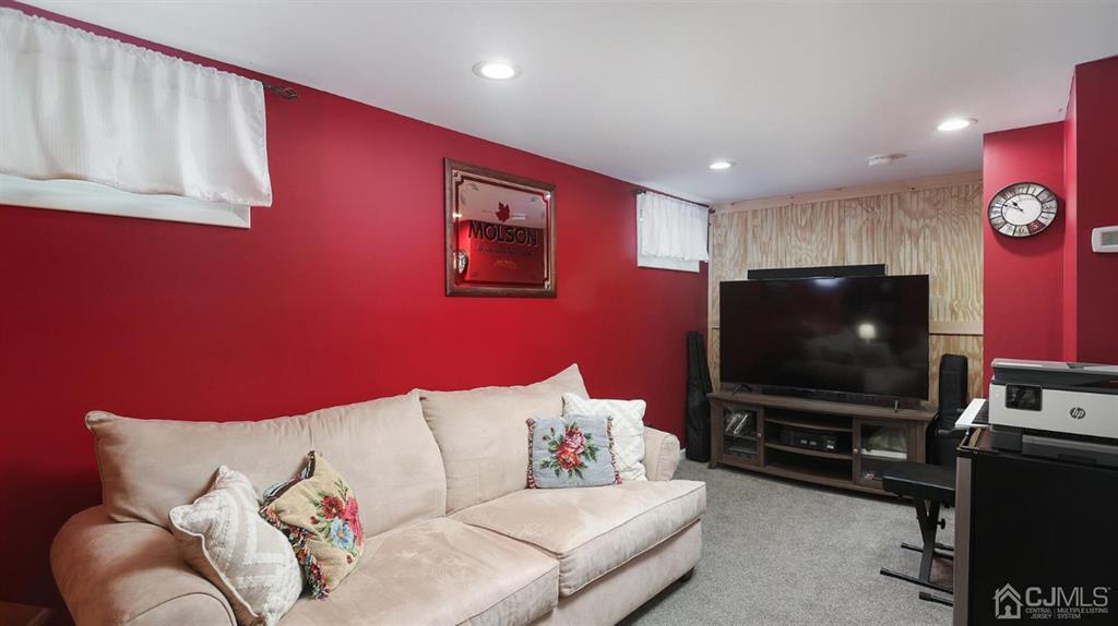 174 South Hill Road Colonia, NJ 07067 - Photo 24 of 31 a living room with furniture and a flat screen tv