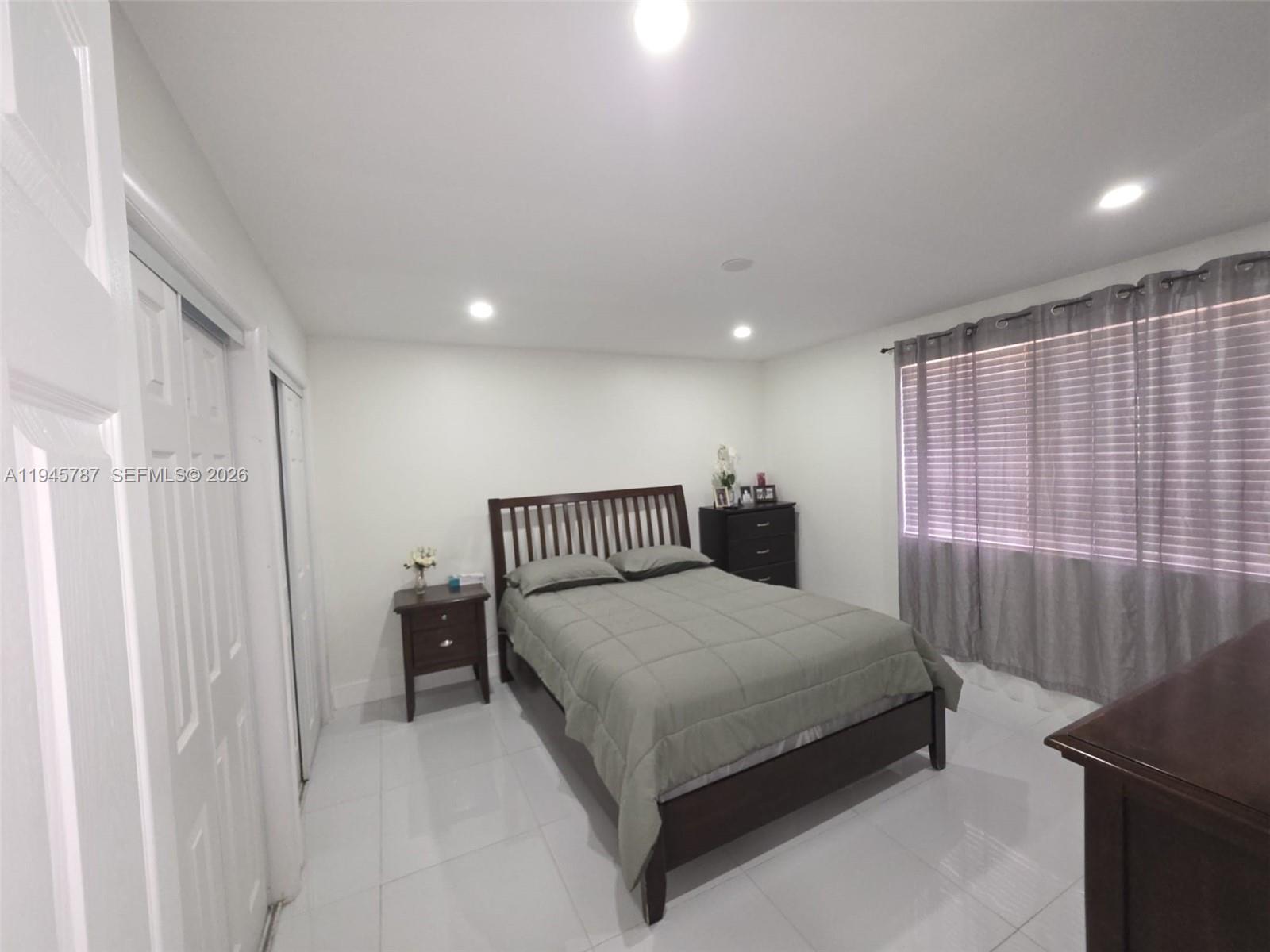 6970 Northwest 186th Street, Unit 3307 Hialeah, FL 33015 - Photo 11 of 21 a bedroom with a bed and a window