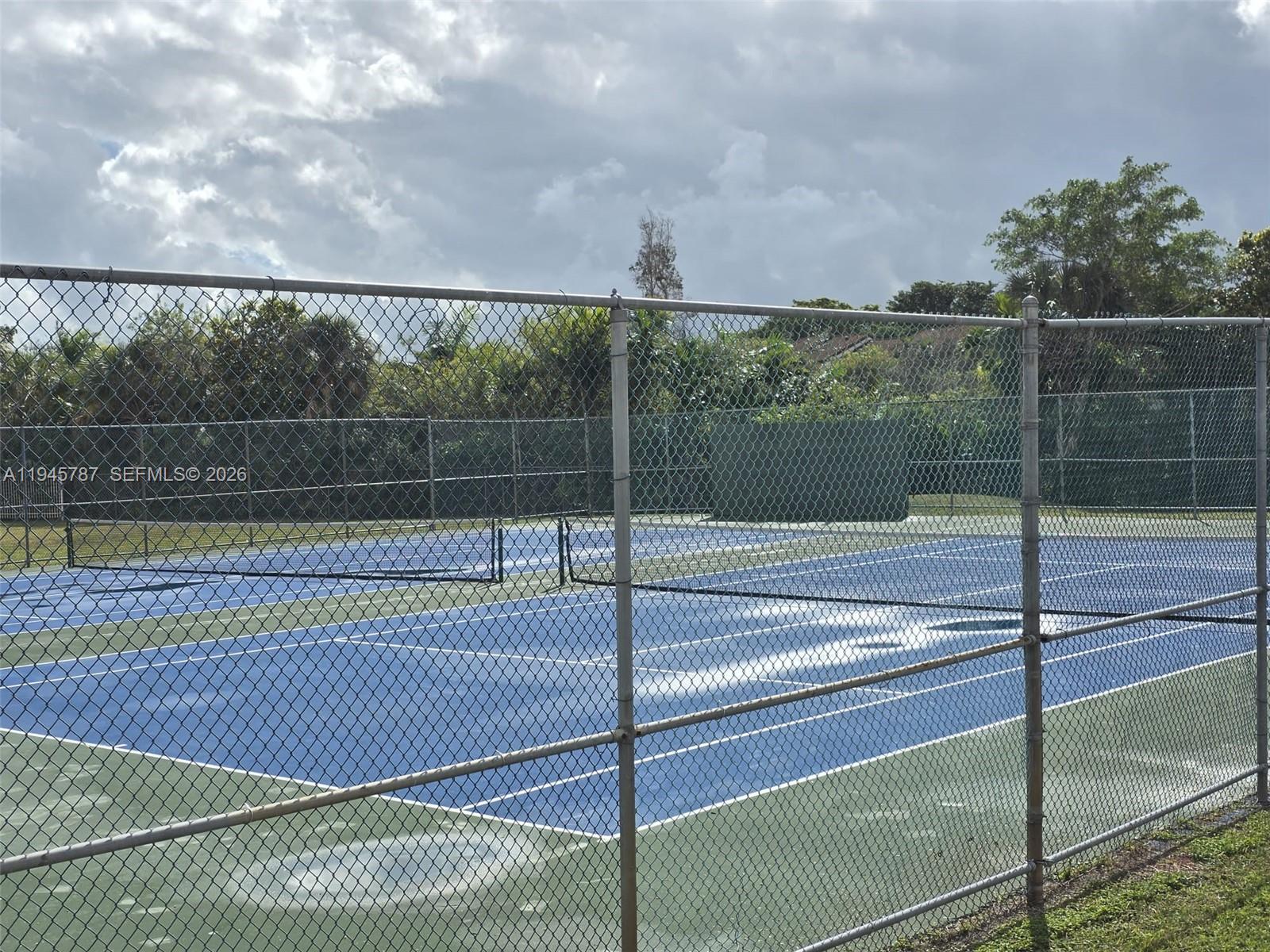 6970 Northwest 186th Street, Unit 3307 Hialeah, FL 33015 - Photo 18 of 21 a view of a tennis court