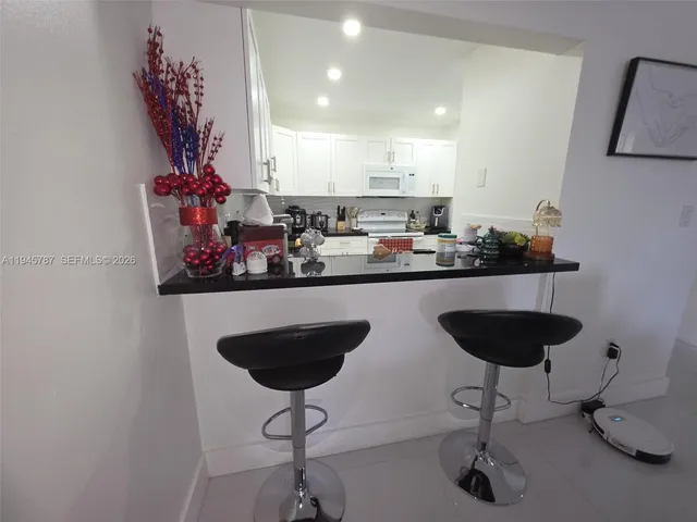 a kitchen with a counter space and a chandelier