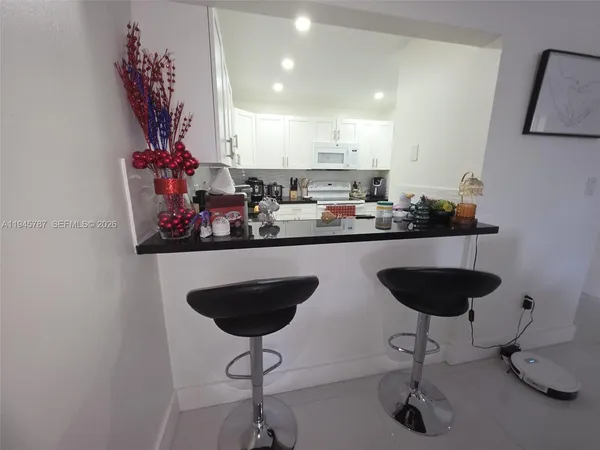 a kitchen with a counter space and a chandelier