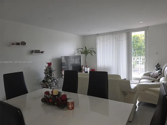 a dining room with furniture window and natural light