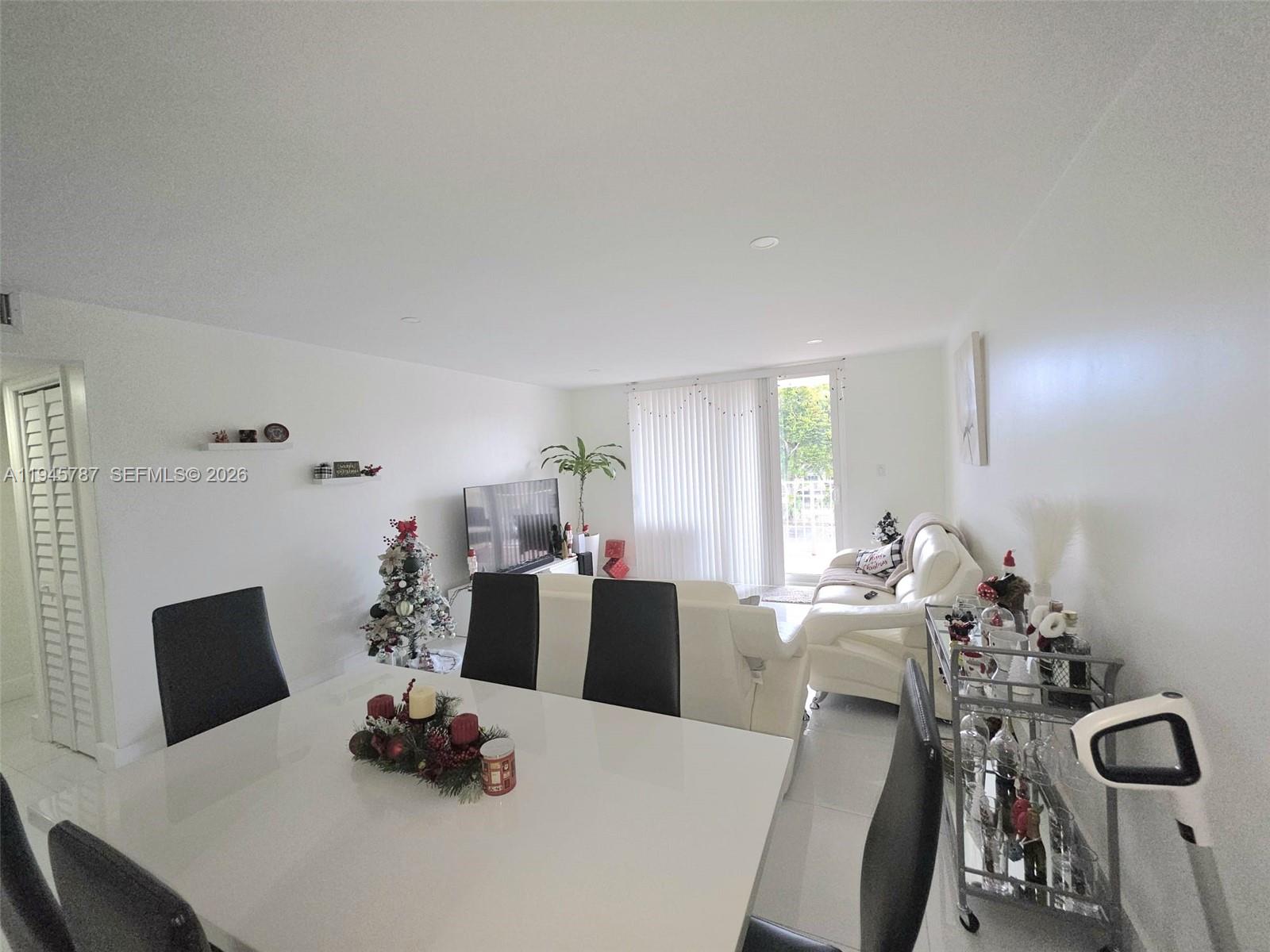 6970 Northwest 186th Street, Unit 3307 Hialeah, FL 33015 - Photo 6 of 21 a view of a dining room with furniture