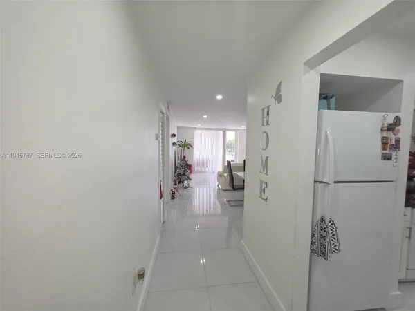 a view of a kitchen with a refrigerator