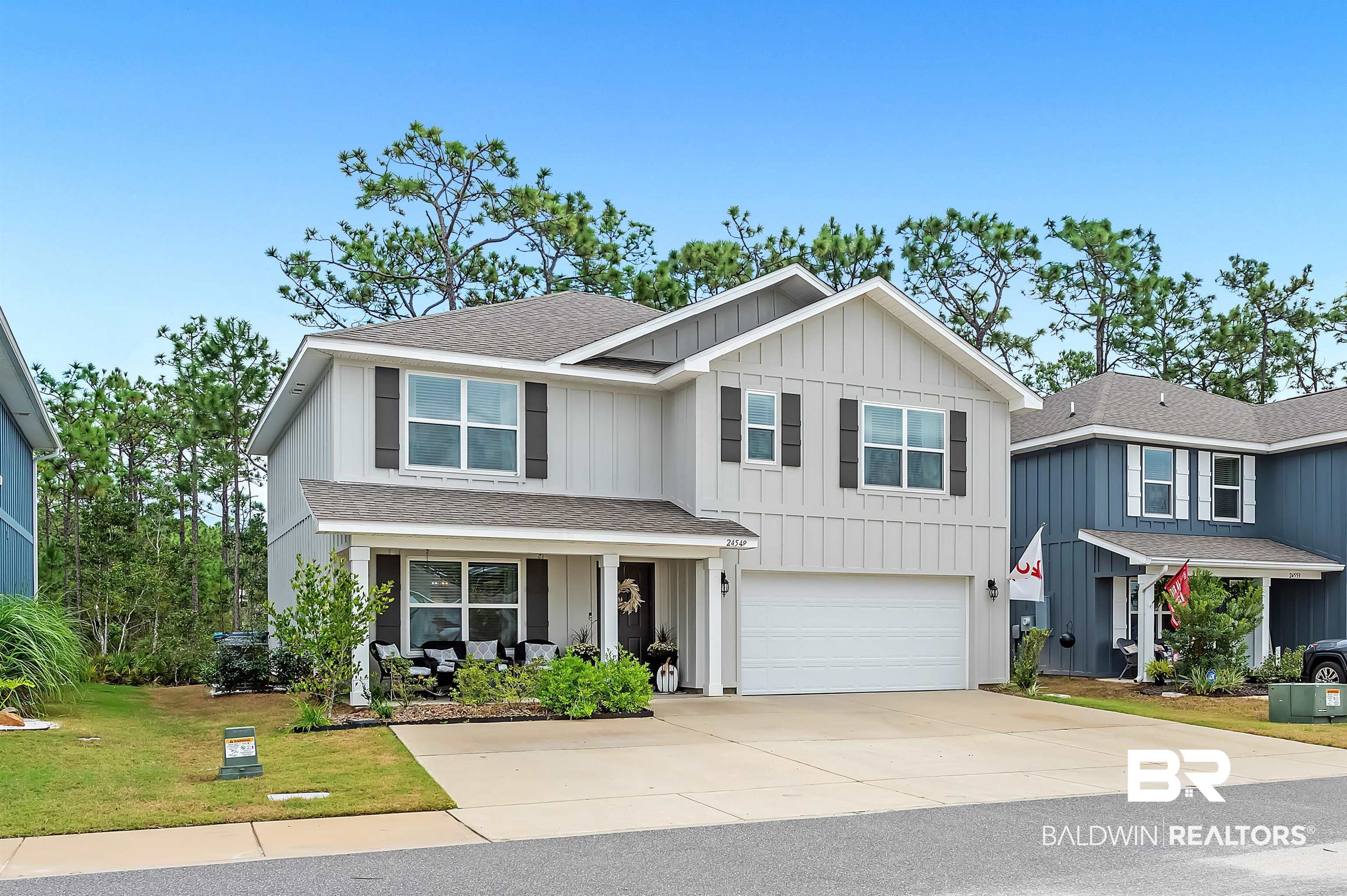 24549 Broken Sound Loop Orange Beach, AL 36561 - Photo 2 of 57 View of front of property with a front lawn and a garage