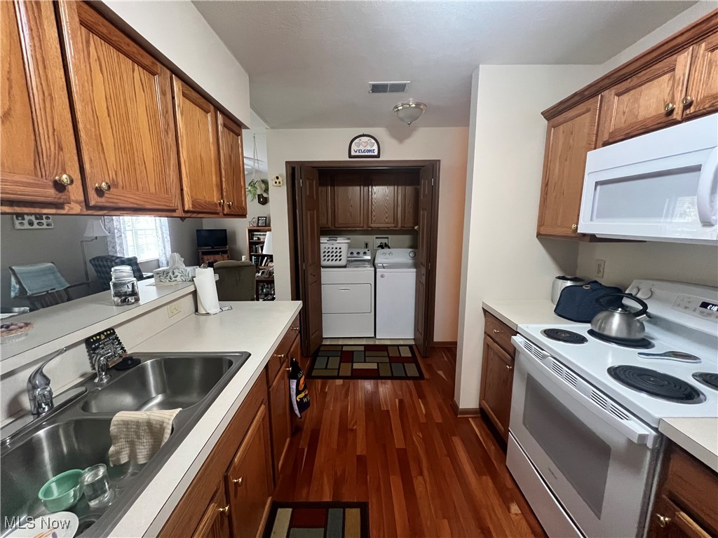 15372B Sprucevale Road East Liverpool, OH 43920 - Photo 5 of 14 Kitchen with sink, dark wood-type flooring, washing machine and dryer, and white appliances