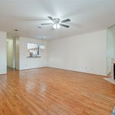 a view of empty room with wooden floor and fireplace