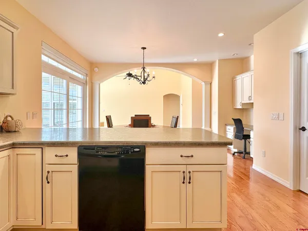 a view of a kitchen with granite countertop a sink and cabinets