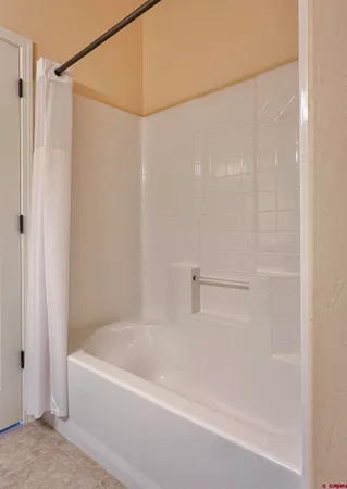 a bathroom with a shower and a bath tub
