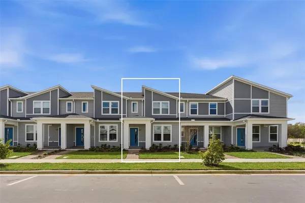 a front view of a residential apartment building with a yard