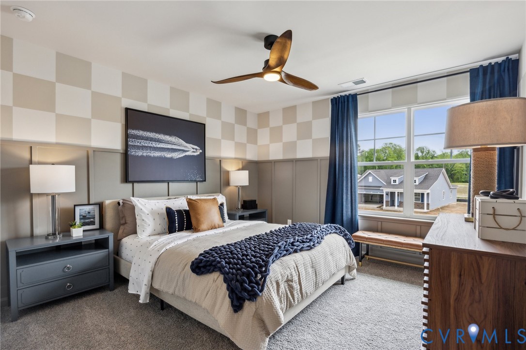 55 Liberty Lane Keswick, VA 22947 - Photo 18 of 34 a bedroom with a bed a chandelier and a flat screen tv