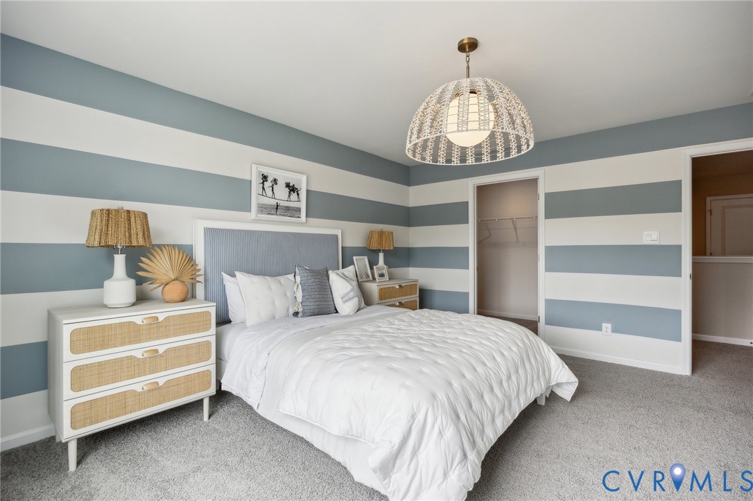 55 Liberty Lane Keswick, VA 22947 - Photo 24 of 34 a bedroom with a bed and a chandelier