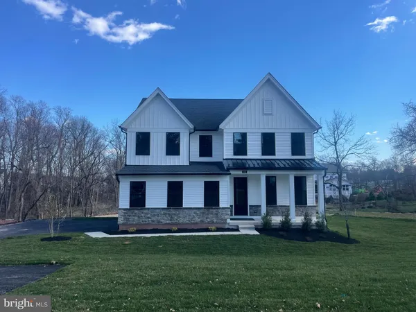a front view of a house with a garden and yard